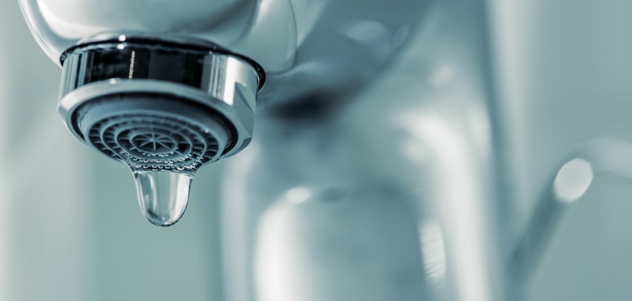Tap with dripping waterdrop. Water leaking, saving.